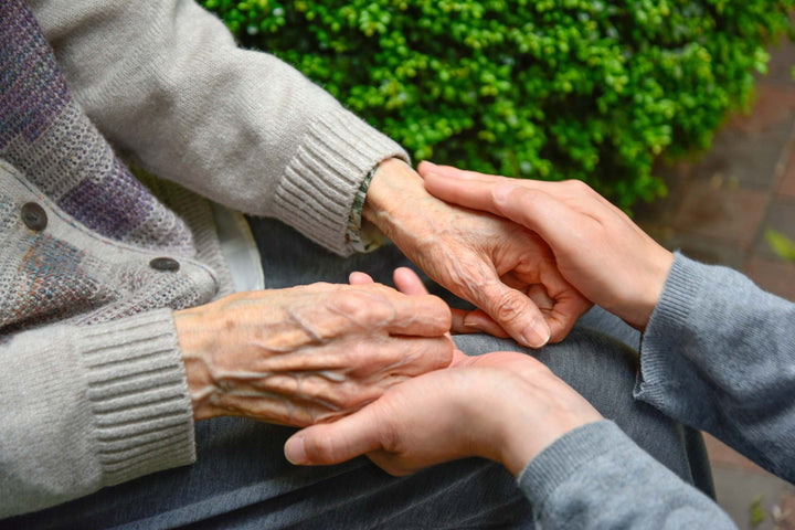 Aegeliss blog picture, caregiver holding loved one's hands