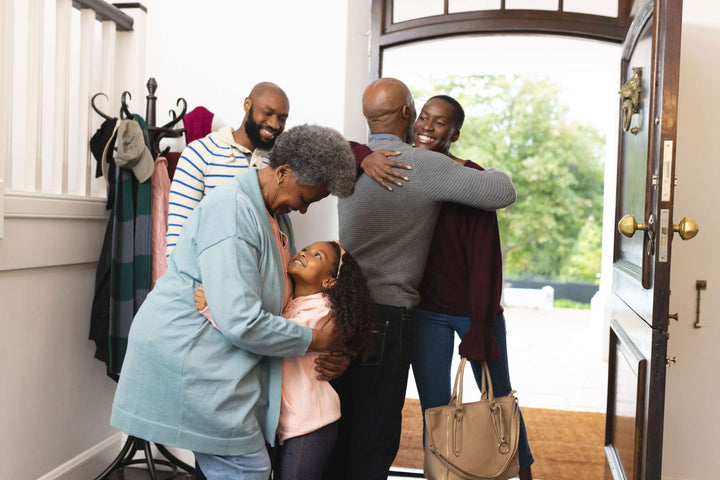 Family portrait of five people sharing hugs and smiles, with Stages of Dementia not depicted in the scene